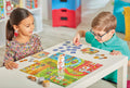 Two children playing a board game together in a colorful room.