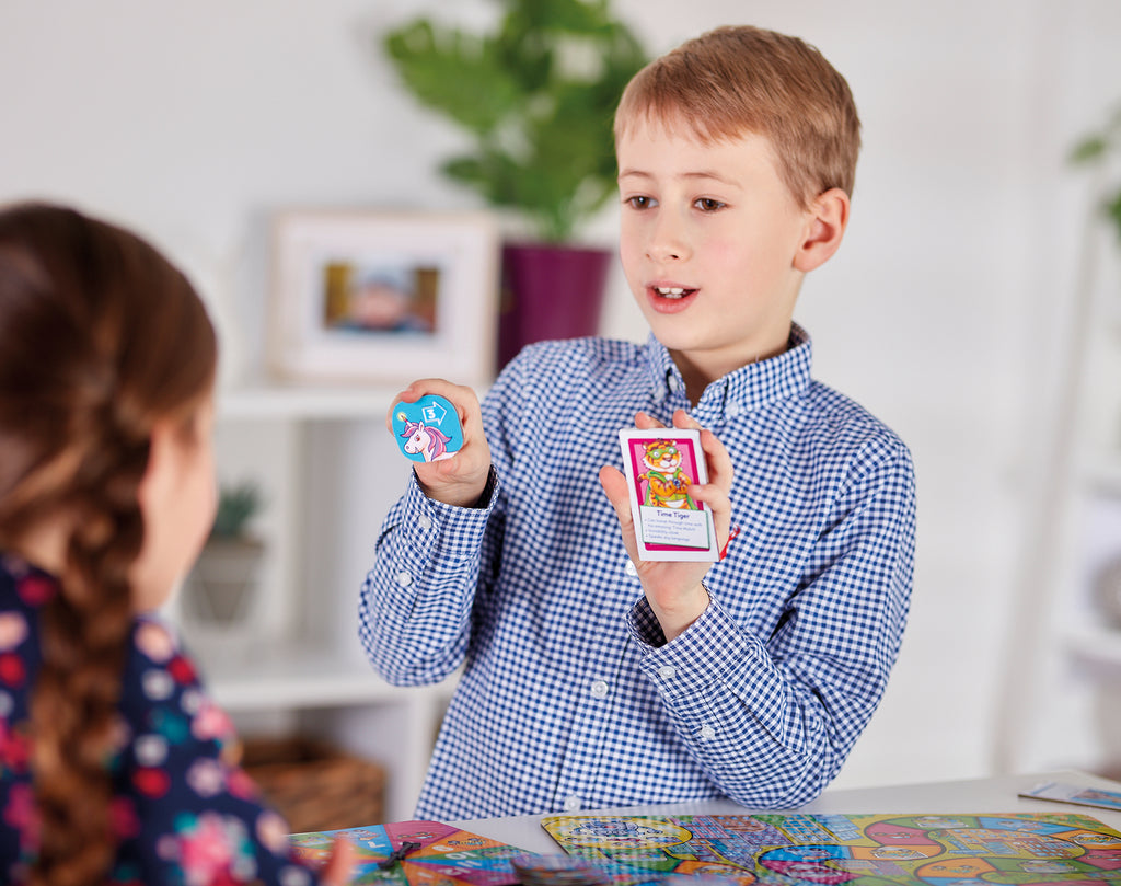 Two children playing with trading cards in a casual indoor setting