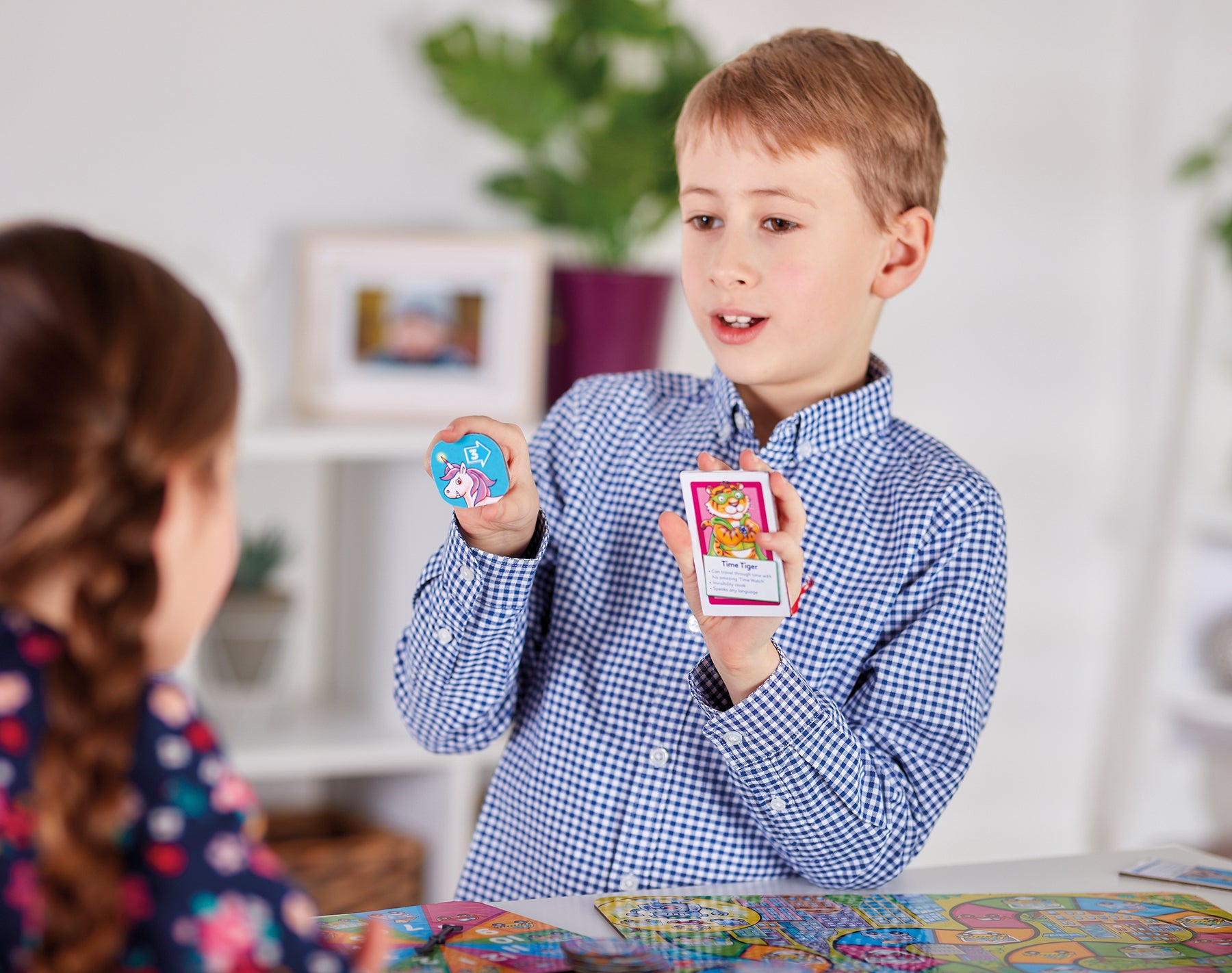 Two children playing with trading cards in a casual indoor setting