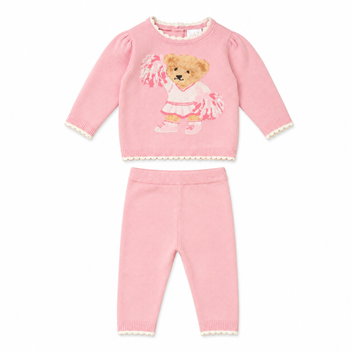 A two-piece baby knit set in light pink, featuring a long-sleeve top with a teddy bear cheerleader applique and matching ribbed leggings with cream lace trim.