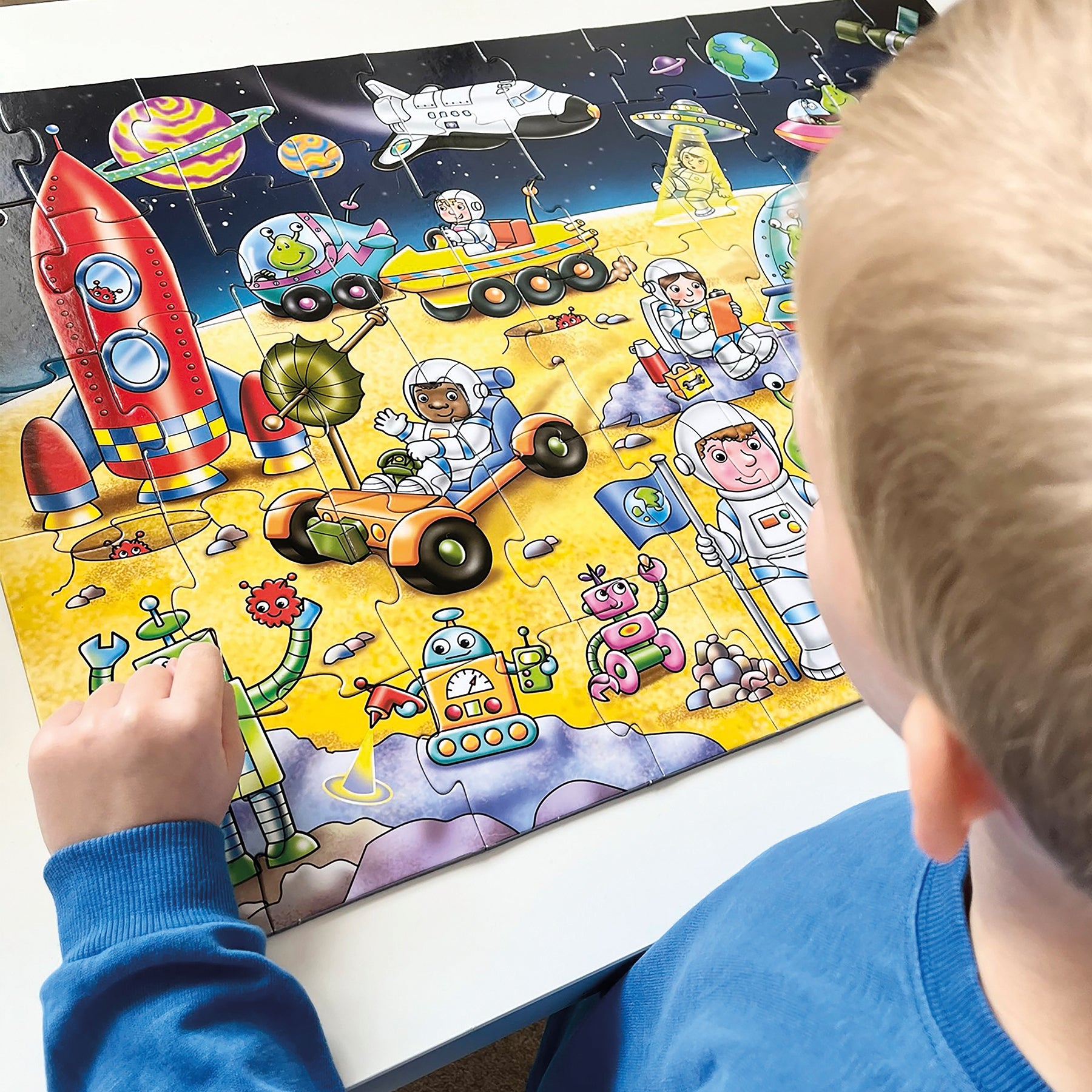 Child playing with a space-themed puzzle