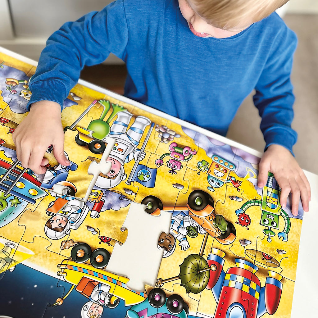 Child playing with a colorful puzzle featuring cartoon characters.