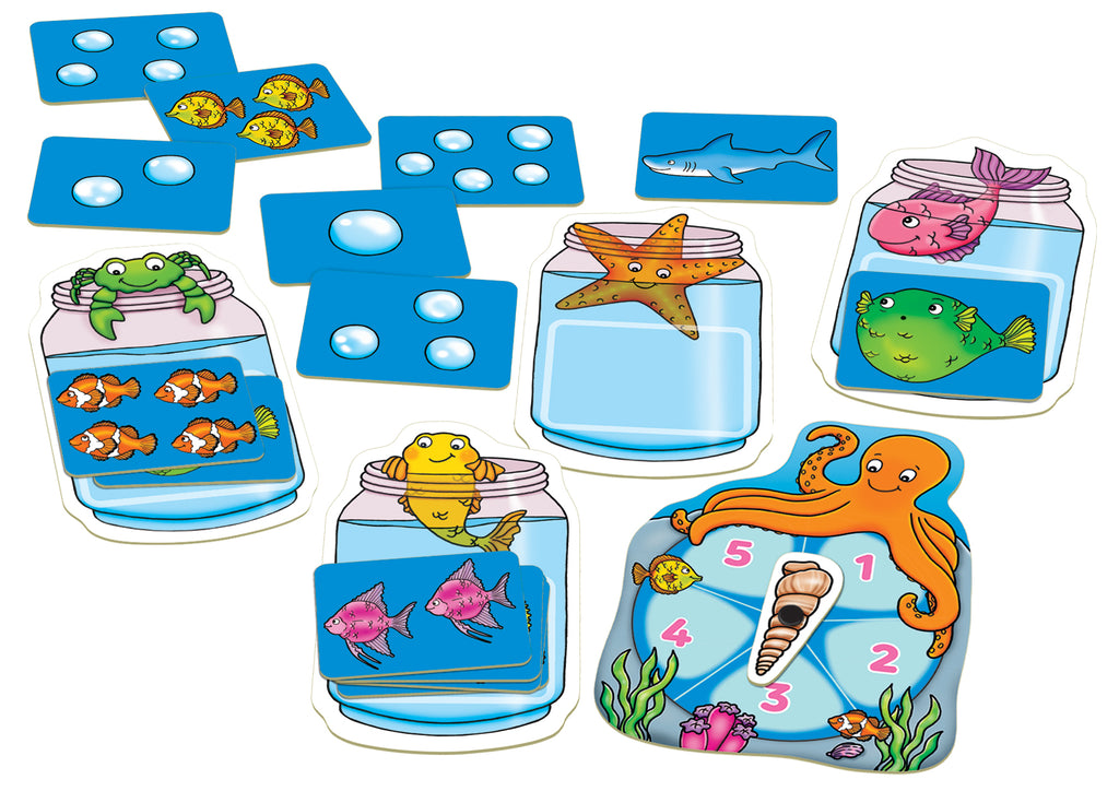 Educational game set with ocean-themed cards and dice on a white background