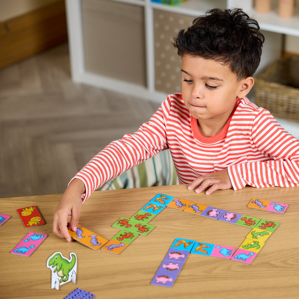 Child playing with colorful card game on a wooden table