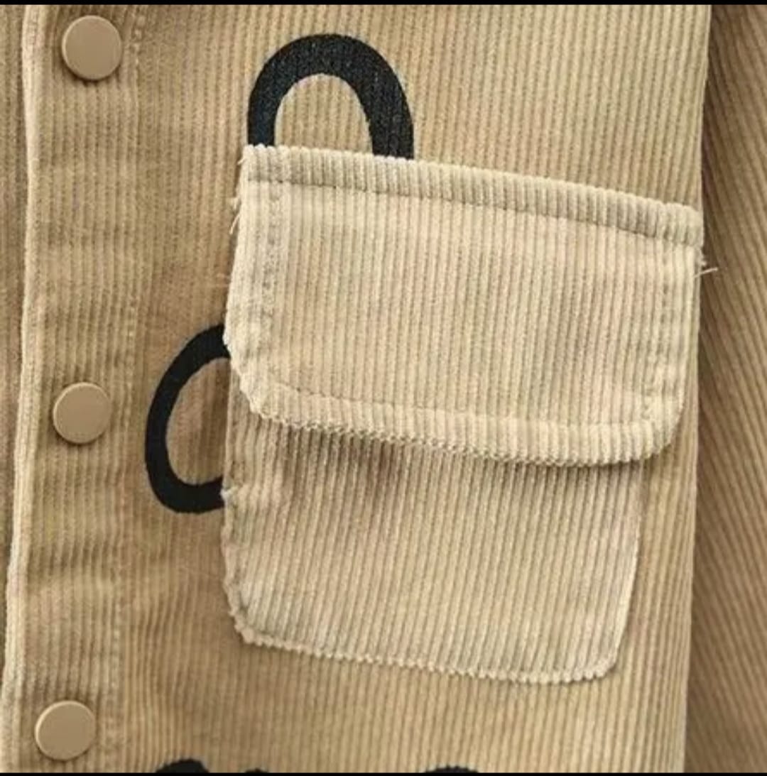 Beige corduroy jacket with a pocket and black handle