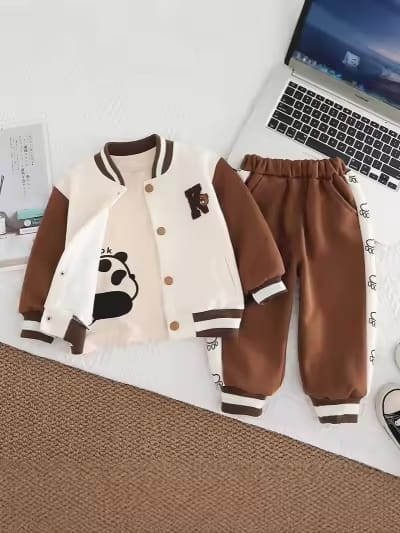 Children's brown and beige jacket with panda design and matching pants on a desk with a laptop.