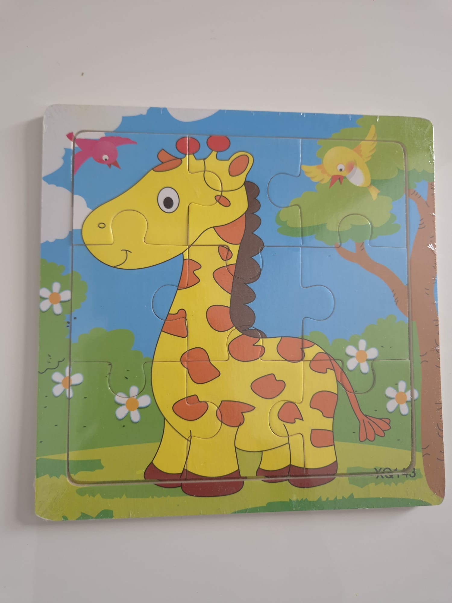 Children's puzzle with a cartoon giraffe on a blue background