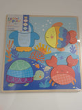 Colorful children's educational board with sea-themed illustrations on a white wall.