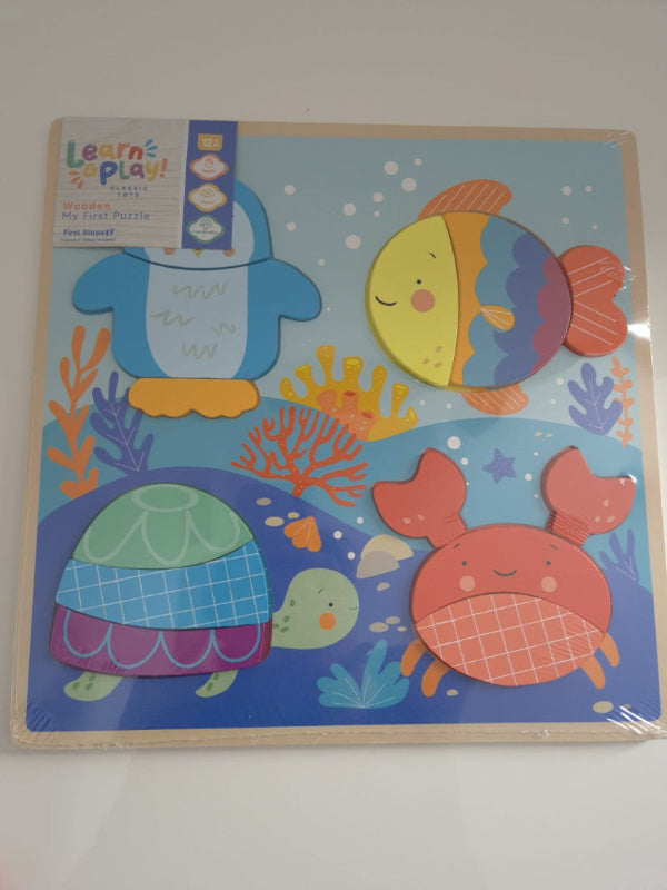 Colorful children's educational board with sea-themed illustrations on a white wall.