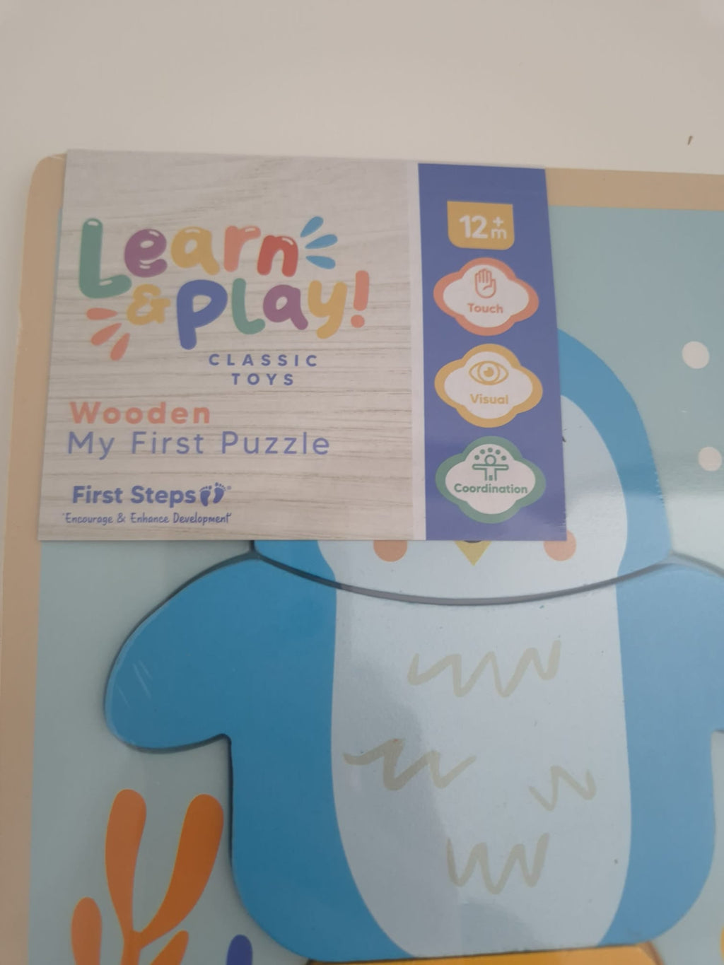 Children's puzzle with 'Learn & Play' branding on a light background
