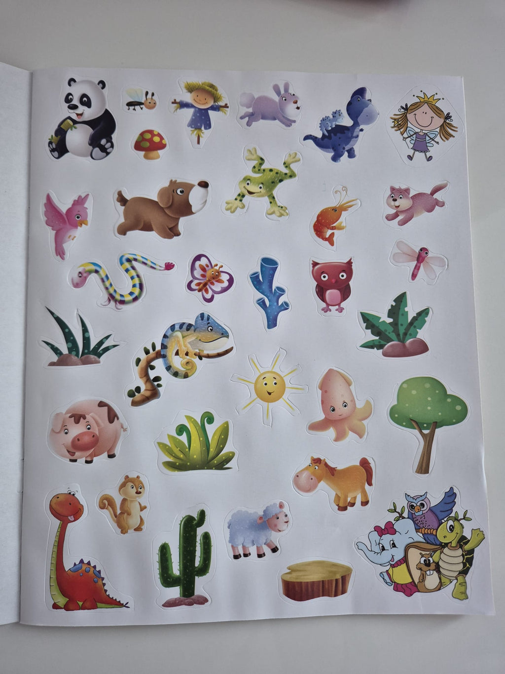 Sticker sheet with various colorful stickers including animals and nature-themed images on a white background.