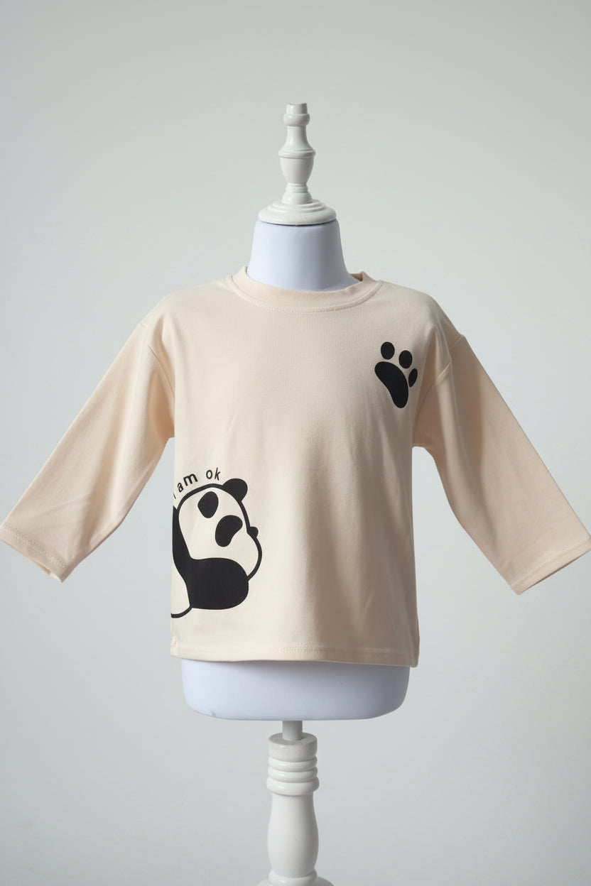 Beige long-sleeve shirt with black paw print design on a mannequin against a gray background