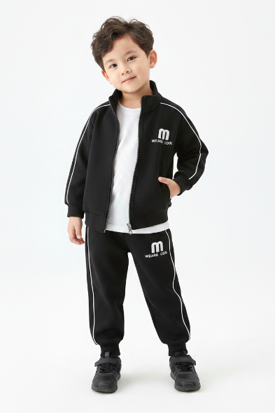 Child wearing black tracksuit in studio